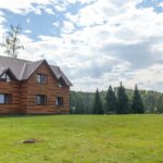 two-storey-wooden-cottage-with-windows-nature-with-a-green-lawn-.jpg